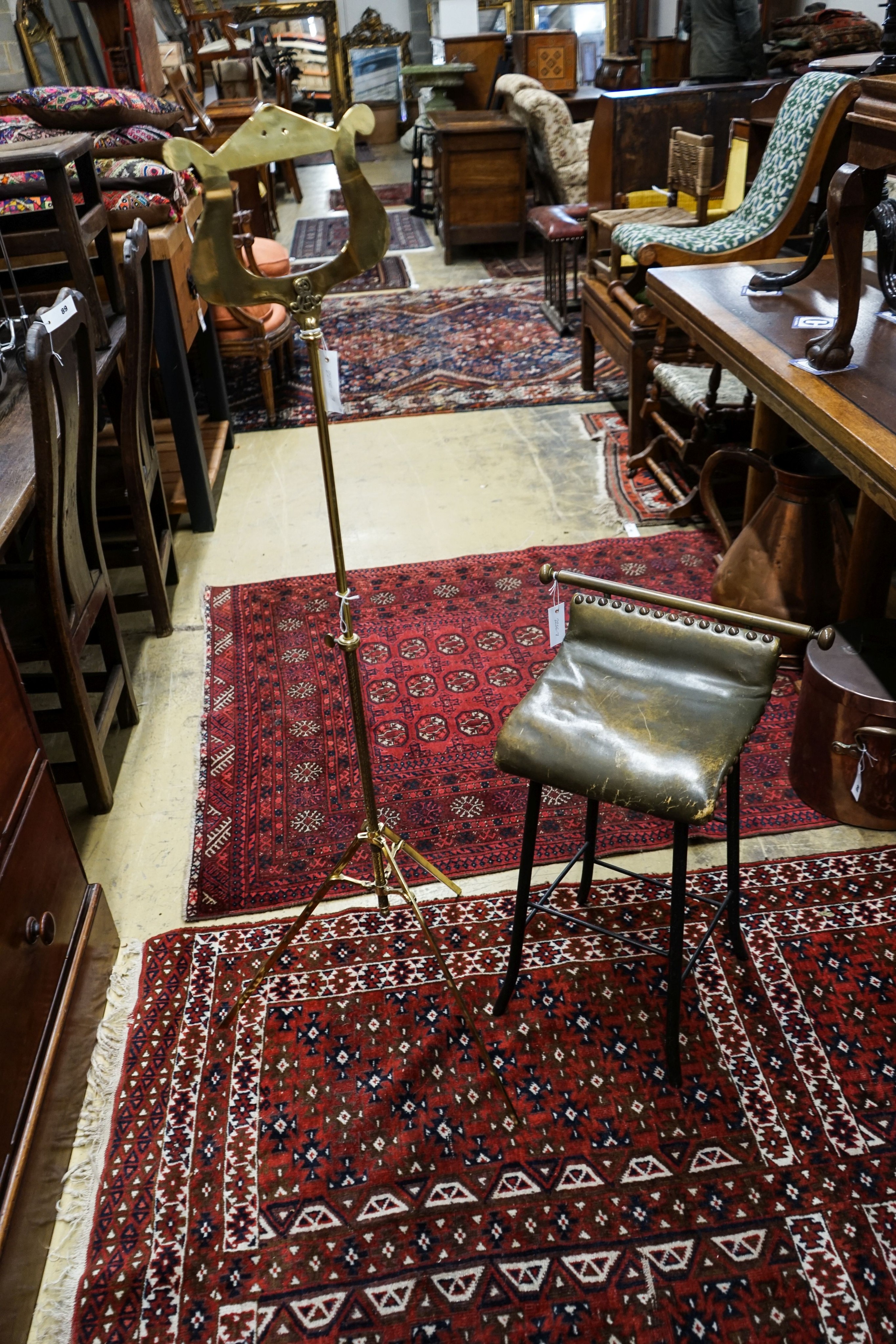 An Edwardian brass music stand and stool